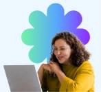 Woman smiling while using a laptop to access online learning.